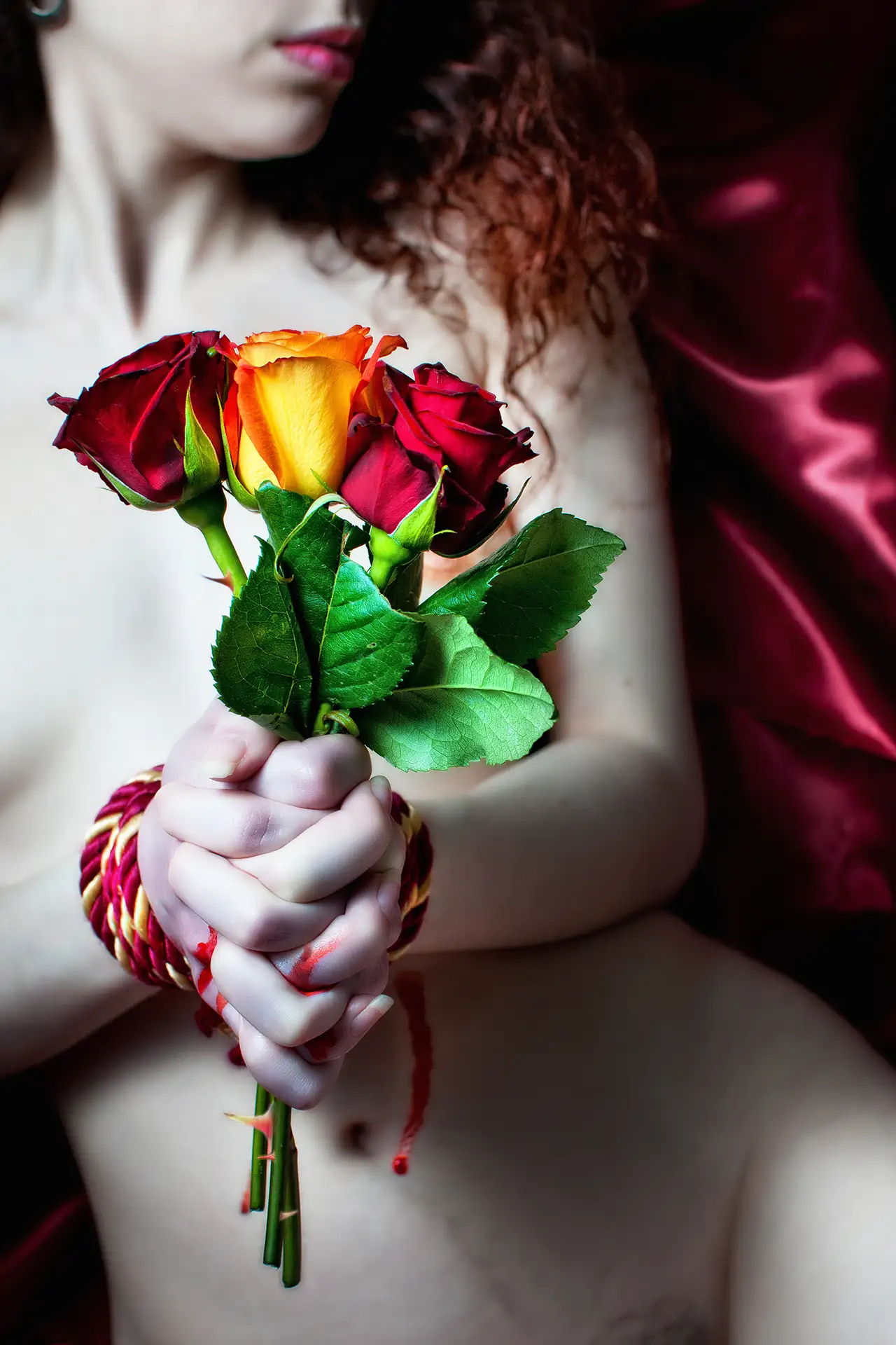 Fine art nude photo. Submissive BDSM, thorny roses.